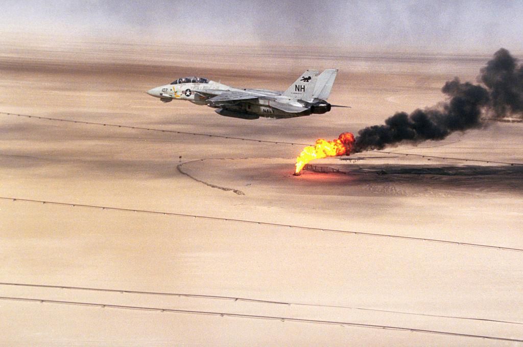 A Fighter Squadron 114 (VF-114) F-14A Tomcat aircraft flies over an oil well still burning in the aftermath of Operation Desert Storm. (Photo by © CORBIS/Corbis via Getty Images)