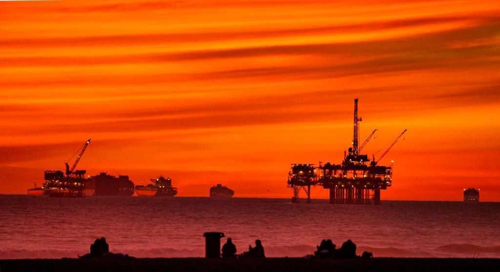 The sun sets over container ships and oil platforms off the coast of Huntington Beach on Tuesday, January 12, 2021. (Photo by Leonard Ortiz/MediaNews Group/Orange County Register via Getty Images)