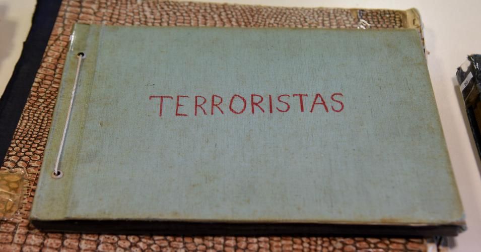 A folder reading "Terrorists" on its cover, that forms part of the "Archives of Terror" is pictured at the Documentation and Archive Center for Human Rights Defense, at the Justice Palace in Asuncion, on January 16, 2019. - The archives that were found in 1992 at a police station in Asuncion, contain the most important documentation of the exchange of intelligence information and prisoners among the military regimes of the region known as "Operation Condor". The files served to order the arrest of former Pa
