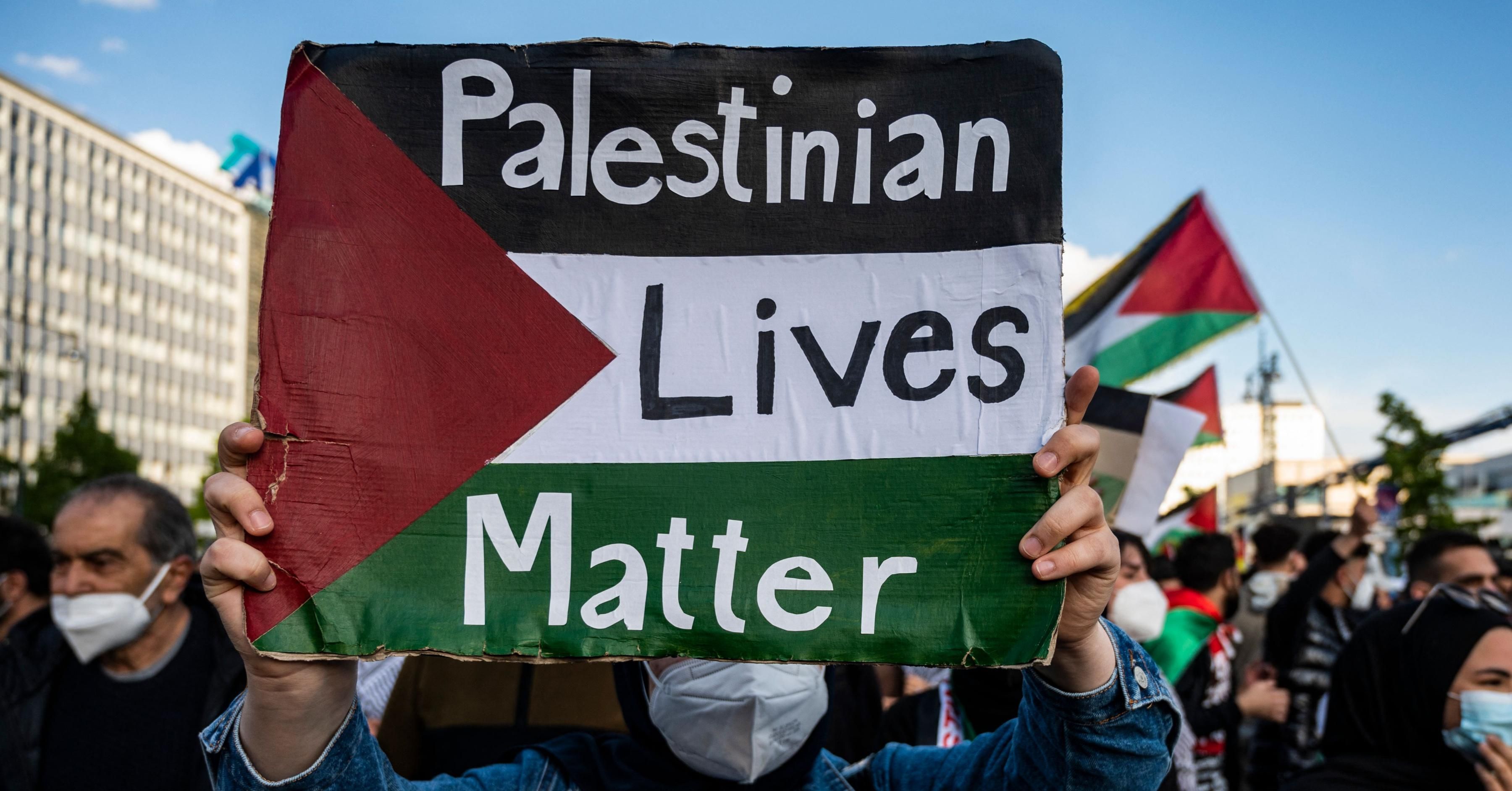 A demonstrator displays a placard reading: "Palestinian Lives Matter" during a pro-Palestinian protest in Berlin on May 19, 2021. Thousands of demonstrators marched waving Palestinian flags and shouting pro-Palestine slogans as Israel and the Palestinians were mired in their worst conflict in years. (Photo: JOHN MACDOUGALL/AFP via Getty Images)