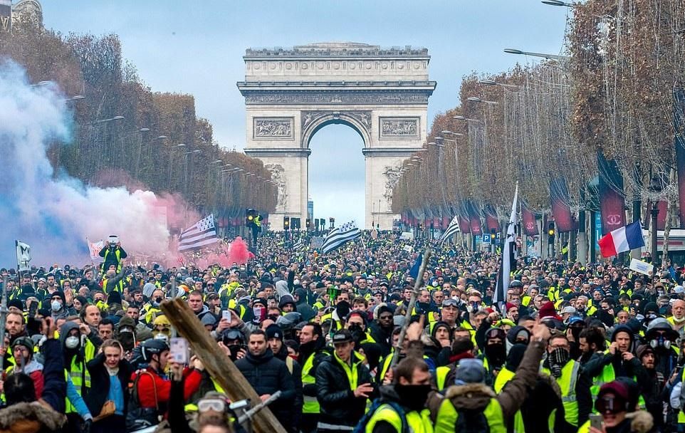 French protesters wear yellow vests as they march in Paris against rising oil prices and living costs near the Arc de Triomphe on the Champs Elysees. (Photo: Olivier Coret/News Pictures/REX/Shutterstock 11/24/18)