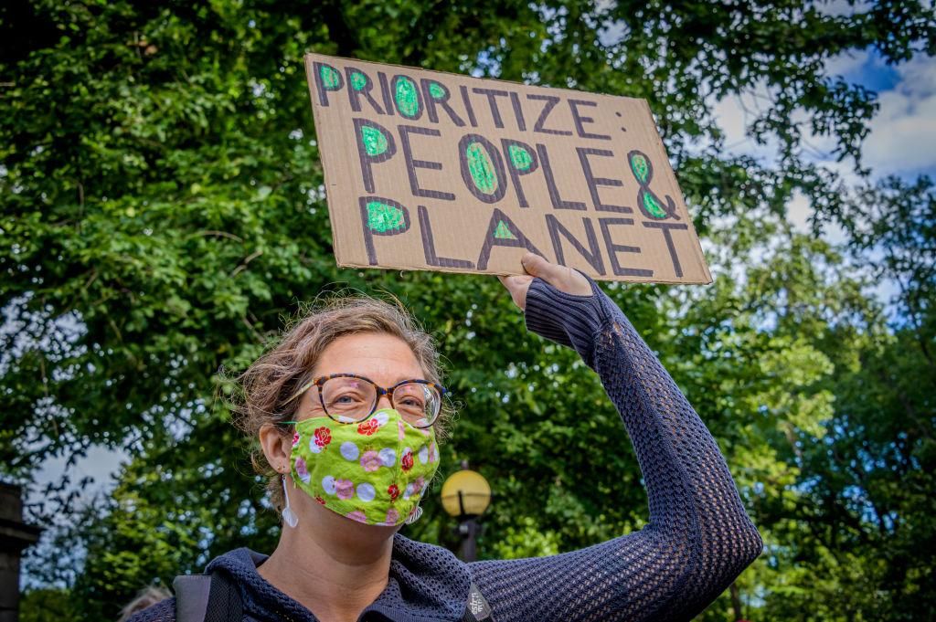 Participant holding a sign at the climate march. A coalition of climate, Indigenous and racial justice groups gathered at Columbus Circle to kick off Climate Week with the Climate Justice Through Racial Justice march. (Photo: Erik McGregor/LightRocket via Getty Images)