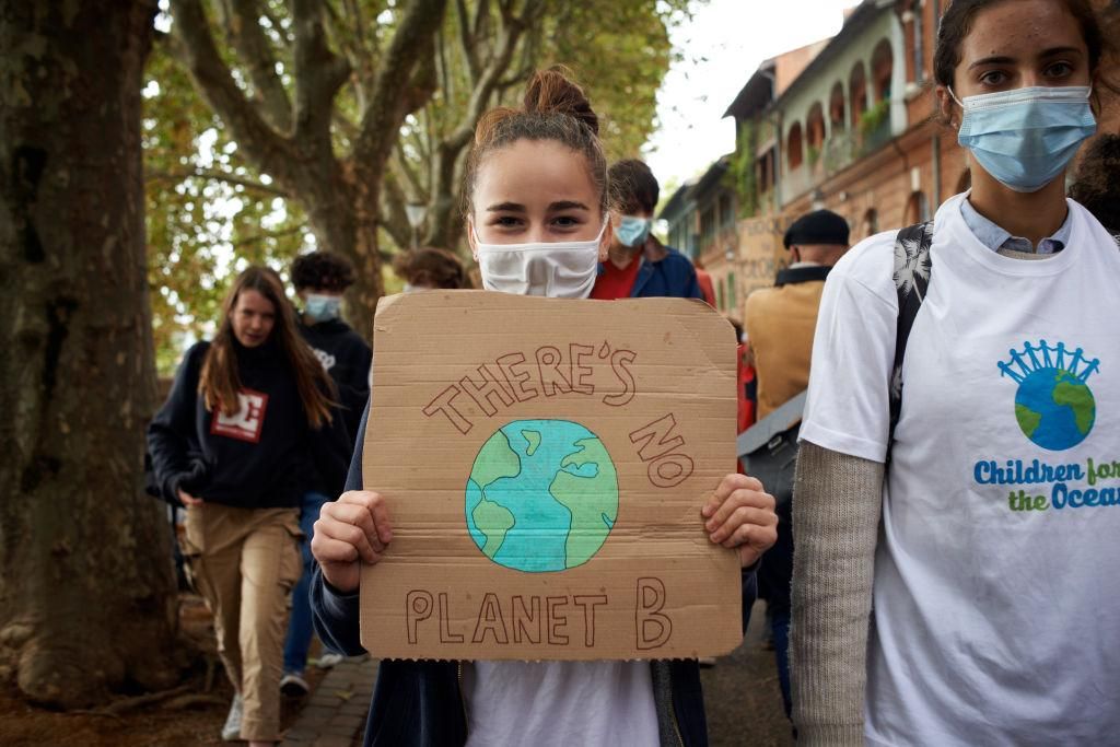 A girl holds a placard reading 'There's no planet B'. (Photo by Alain Pitton/NurPhoto via Getty Images)