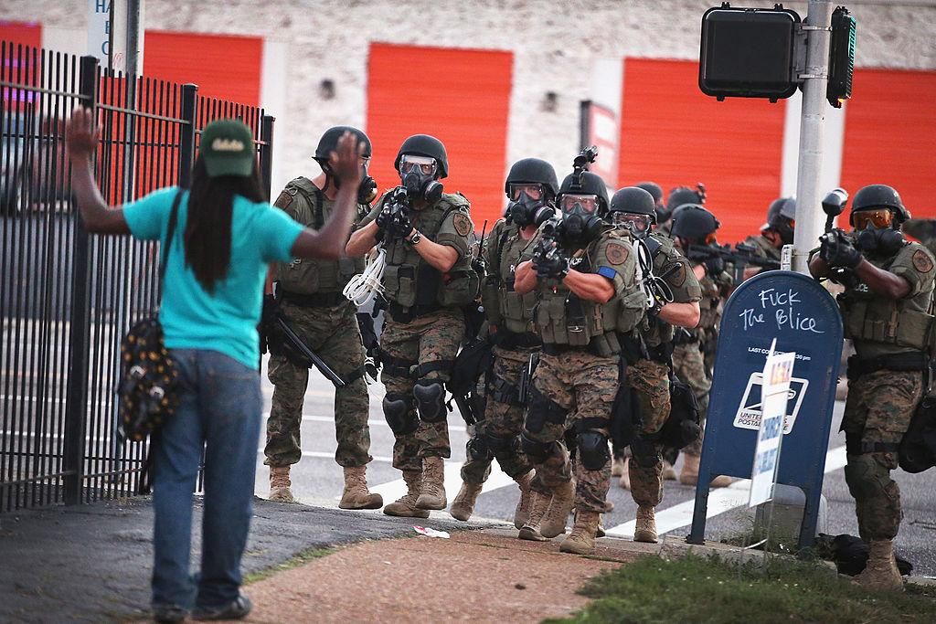 Beyond the gear and surveillance, however, perhaps the most damaging effect of war on terror-encouraged police militarization is psychological. It pushes police officers engaging with the public to behave as they look, to act like soldiers dealing with enemy combatants. (Photo by Scott Olson/Getty Images)