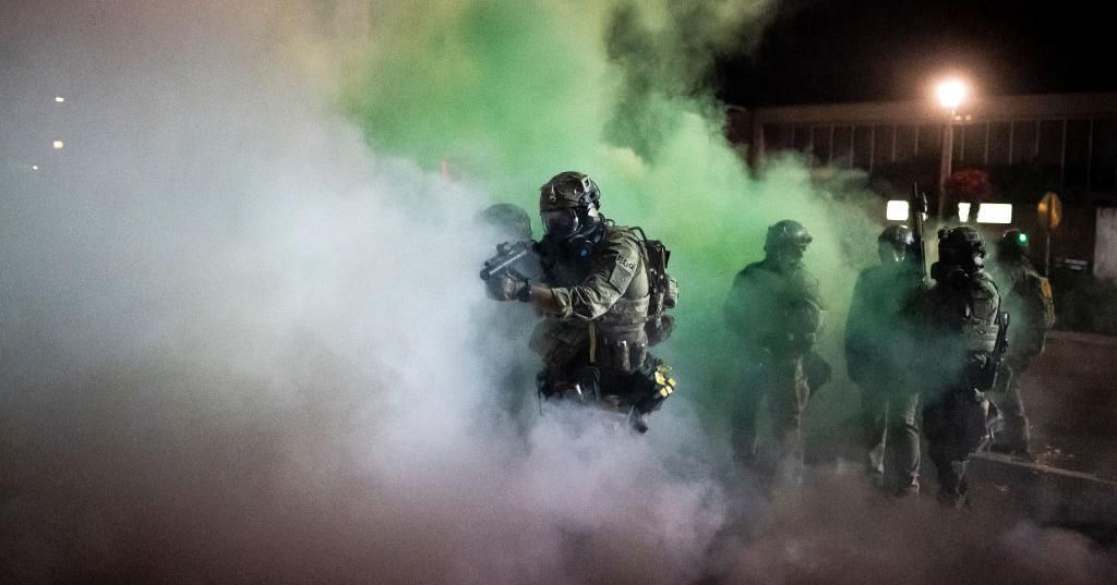 Federal officers walk through tear gas during a dispersal of about 300 protesters in front of the Immigration and Customs Enforcement (ICE) detention building on August 26, 2020 in Portland, Oregon. Protests continued for the 91st night in Portland as activist called for solidarity with rallies in Kenosha, Wisconsin. (Photo: Nathan Howard/Getty Images)