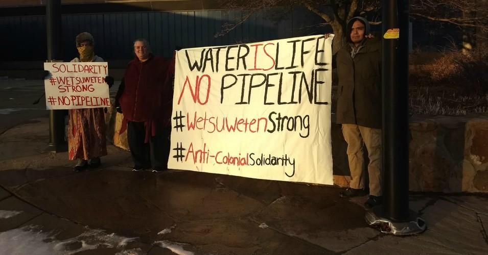Demonstrators hold signs to protest the construction of TransCanada's Coastal GasLink through unceded Wet'suwet'en territory.