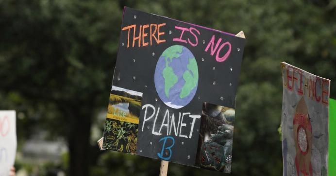 Sign reads: There is no planet B.