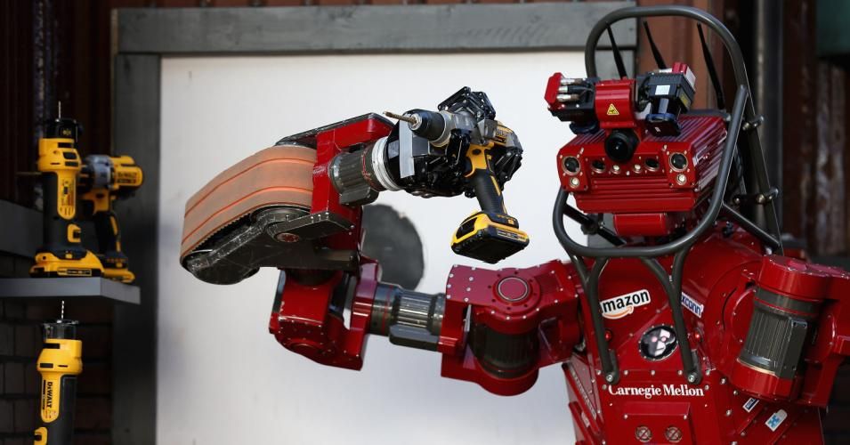 Team Tartan Rescue's CHIMP (CMU Highly Intelligent Mobile Platform) robot uses a hand-held power tool during the cutting task of the Defense Advanced Research Projects Agency (DARPA) Robotics Challenge on June 6, 2015 in Pomona, California. (Photo: Chip Somodevilla/Getty Images)