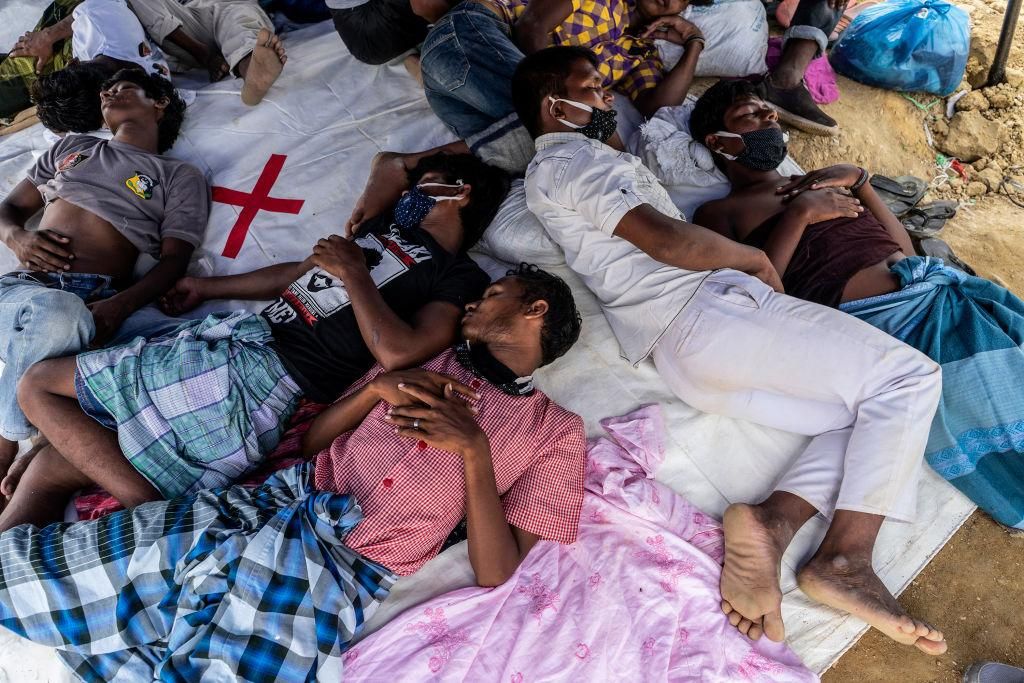 Rohingya refugees take a rest under tent at temporary shelter in Lhokseumawe, Aceh, Indonesia on September 8, 2020. Nearly 300 Rohingya people stranded on the beach off Lhokseumawe on early Monday morning. (Photo by Zick Maulana/NurPhoto via Getty Images)