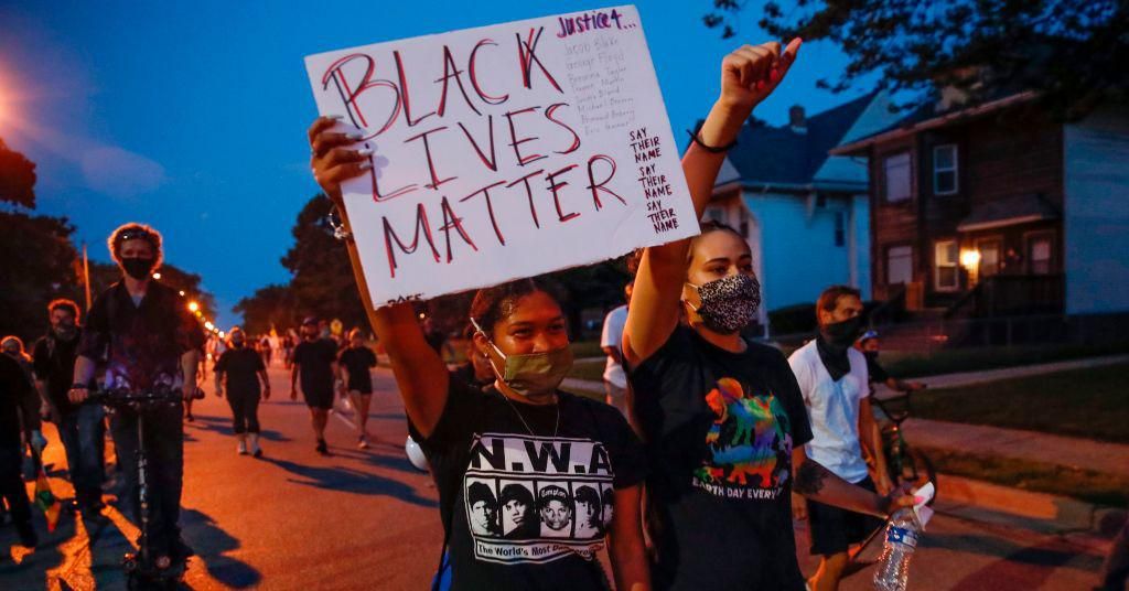 A protester holds a Black Lives Matter sign during a demonstration against the shooting of Jacob Blake in Kenosha, Wisconsin on August 26, 2020. (Photo: Kamil Krzaczynski/AFP via Getty Images)