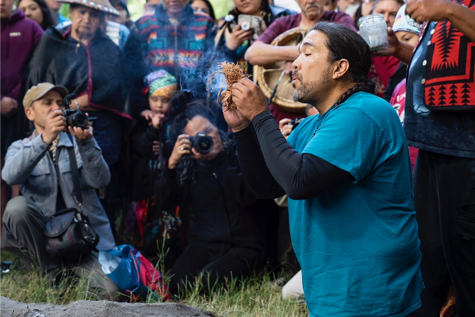 Nisqually Tribal Council Member Hanford McCloud lights sacred fire to open up 17th Protecting Mother Earth conference. (Photo: Rudi Tcruz)
