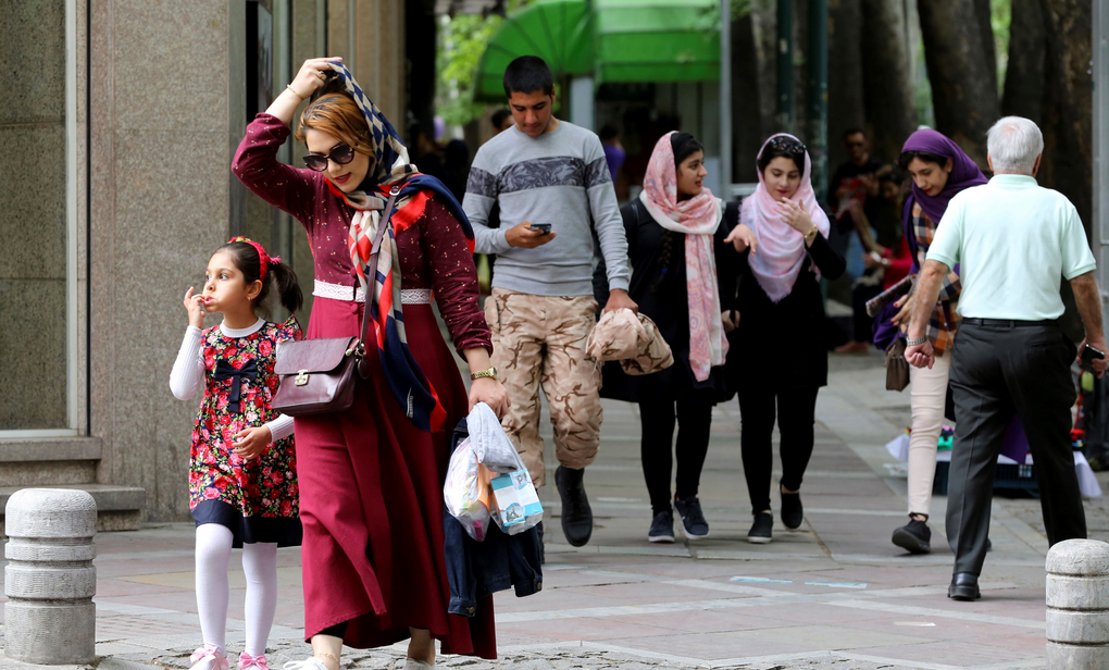Iranians walk in Valiasr Street in northern Tehran on 8 May. (Photo: AFP/Getty)