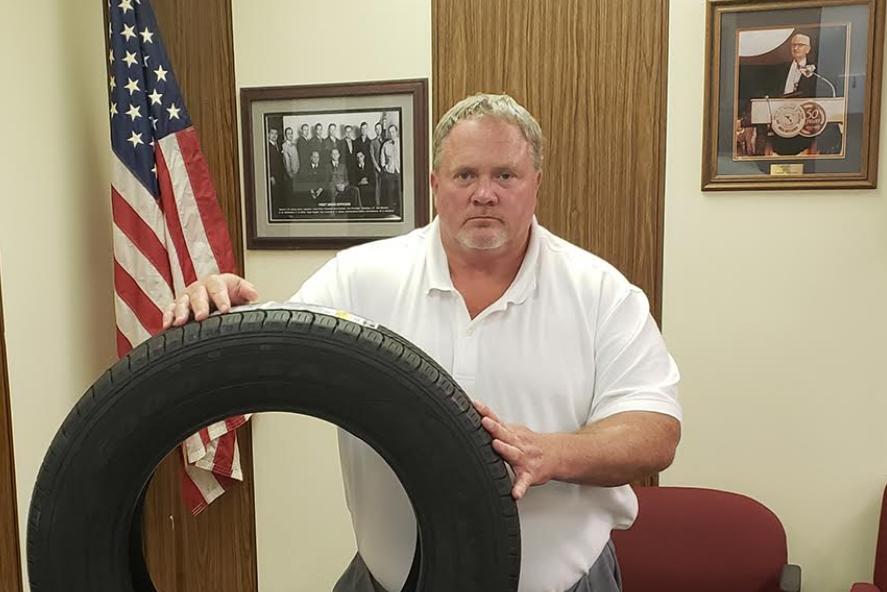 Mickey Ray Williams, president of the USW local union at the Goodyear plant in Gadsden, Alabama, with a tire made in Mexico. 