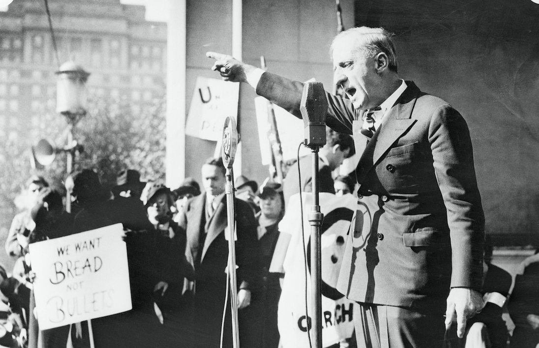 11/9/35: General Smedley D. Butler, U.S. Marines, retired, pictured as he addressed a crowd of 6,000 participants in an anti-war demonstration on Reyburn Plaza, Philadelphia, Nov. 9th. Butler suggested, "That the government pay business and commercial interests not to trade with warring nations." (Photo: Bettman/Getty)