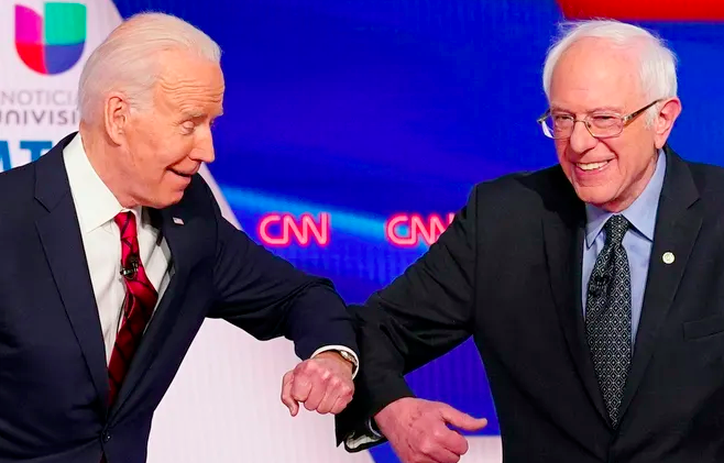 Joe Biden and Bernie Sanders bump elbows before the Democratic debat hosted by CNN on Sunday, March 15, 2020. (Photo: Mandel Ngan/AFP/Getty Images)