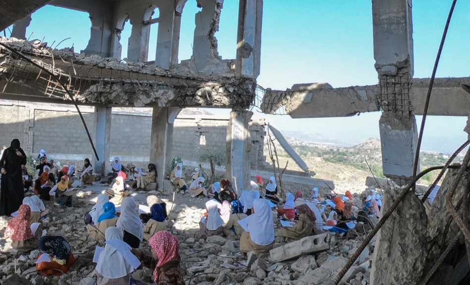  Yemeni children study in the rubble of their school, which was destroyed by the violent war in the city of Taiz, Yemen 23 Dec 2018 (Photo: Akramalrasny via shutterstock.com) 