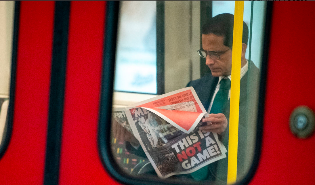 A commuter reads a newspaper with the headline "This Is Not A Game!" as he travels on an underground train just after 9am, during what would usually be the busy morning rush hour period, on March 23, 2020 in London, United Kingdom. (Photo: Leon Neal/Getty Images)