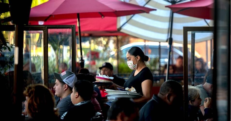 A server clears a table as patrons dine outdoors at Gloria's Cocina Mexicana in Ontario, California on December 5, 2020. (Photo: Watchara Phomicinda/MediaNews Group/The Press-Enterprise via Getty Images)