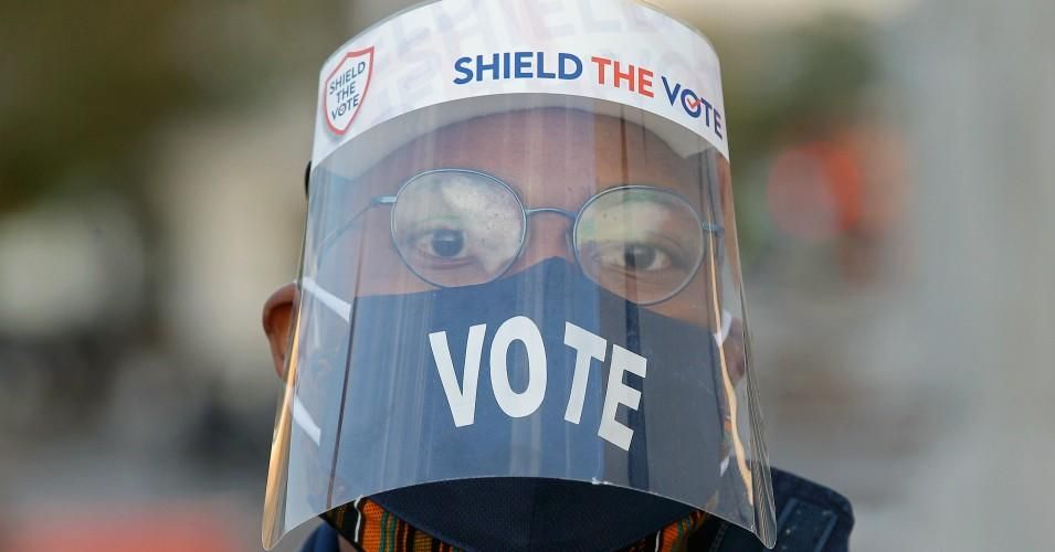 A voter wears a face mask and a face shield outside a polling station on Election Day during the 2020 general elections. (Photo: Yegor Aleyev\TASS via Getty Images)