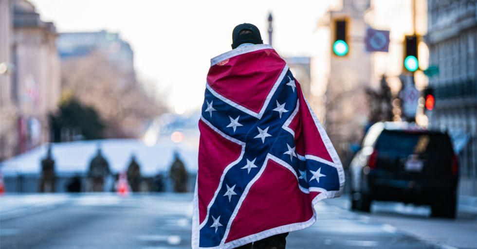 A Trump supporter in Washington, D.C., draped in the Confederate battle flag. (Photo: Shutterstock)