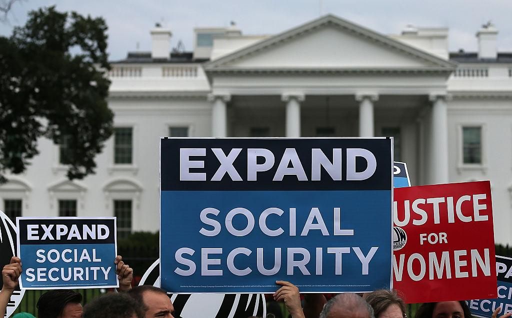 Activists participate in a rally urging the expansion of Social Security benefits in front of the White House July 13, 2015 in Washington, DC. Social Security Works, the AFL-CIO and additional organizations held the event to deliver "more than 2 million petition signatures" in support of expanding Social Security benefits. (Photo by Win McNamee/Getty Images)