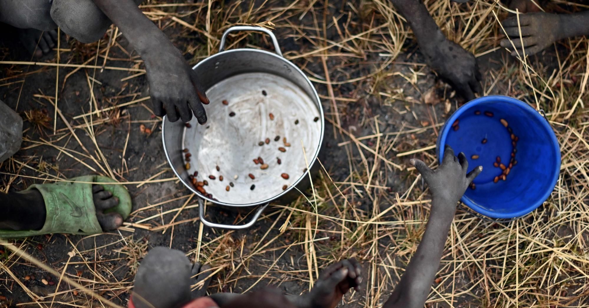 Children collect grain spilt on the field from gunny bags that ruptured upon ground impact during a food drop at a village in Ayod County, South Sudan on February 6, 2020. The 2021 Global Report on Food Crises categorized 133,000 people in Burkina Faso, South Sudan, and Yemen as being in "catastrophe," meaning that they need immediate action to prevent widespread death and collapse of livelihoods. (Photo: Tony Karumba/AFP via Getty Images) 