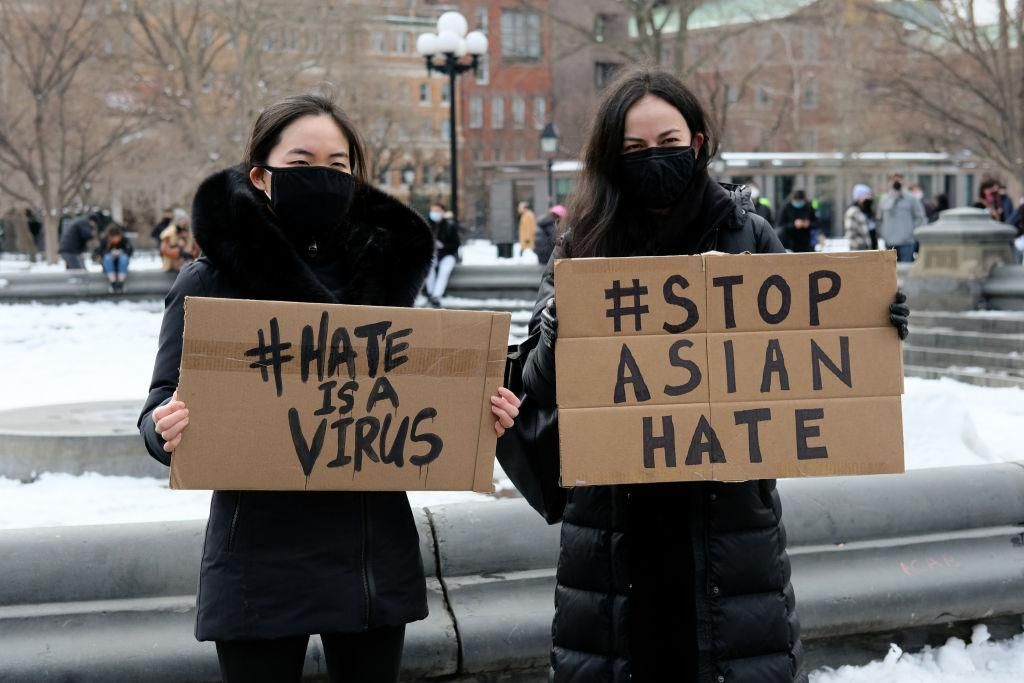 Protestors hold signs that read "hate is a virus" and "stop Asian hate" at the End The Violence Towards Asians rally in Washington Square Park on February 20, 2021 in New York City. Since the start of the coronavirus pandemic, violence towards Asian Americans has increased at a much higher rate than previous years. The New York City Police Department (NYPD) reported a 1,900% increase in anti-Asian hate crimes in 2020. (Photo by Dia Dipasupil/Getty Images)
