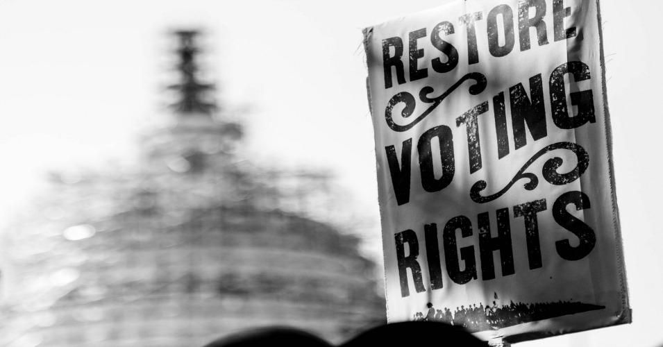 Sign reads: "Restore voting rights"