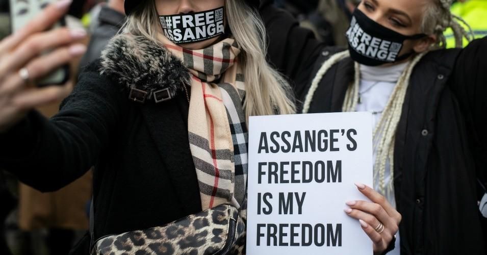 Protestors wear "#FREEASSANGE" face masks outside Belmarsh prison prior to Julian Assange's extradition hearing on February 24, 2020 in London.