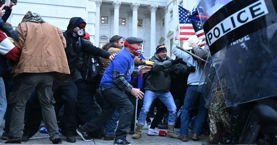 Trump supporters clash with police and security forces, as they storm the U.S. Capitol in Washington, DC, on January 6, 2021. 