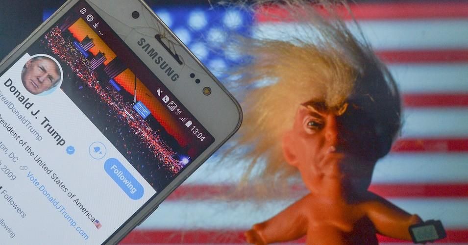 Donald Trump's Twitter account displayed on a mobile phone screen next to a vinyl doll which features the U.S. President Donald Trump, seen in front of the U.S. flag, on Saturday, 9 January 2021, in Dublin, Ireland. (Photo: Artur Widak/NurPhoto via Getty Images)