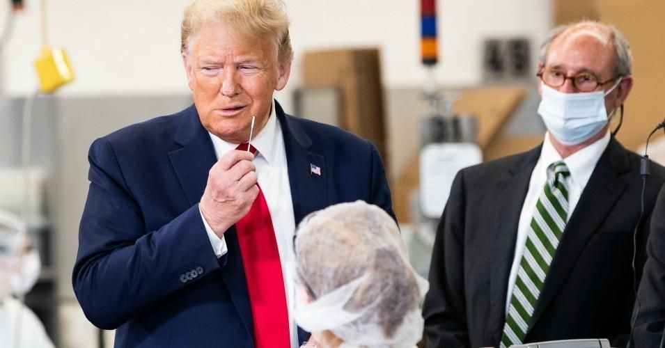 President Donald Trump pretends to take a Covid-19 test while holding a swab during his visit of the Puritan Medical Products facility in Guilford, Maine on June 5, 2020. The facility said after Trump's visit it would have to discard tests that were made during the president's visit because he did not wear a face mask. (Photo: Nicholas Kamm/AFP via Getty Images)