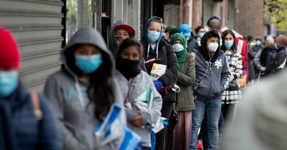 Citizens wearing protective masks form lines to receive free food from a food pantry run by the Council of Peoples Organization on May 8, 2020 in Brooklyn. (Photo: Andrew Lichtenstein/Corbis via Getty Images)