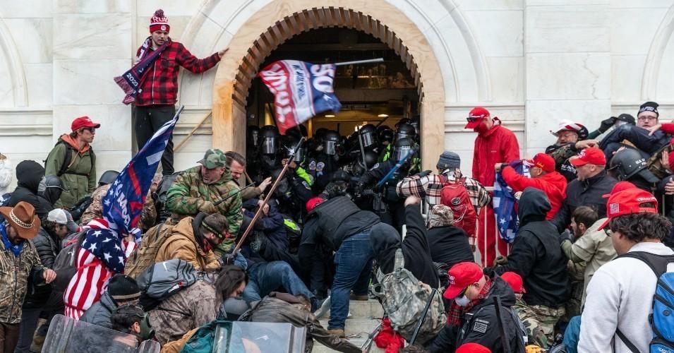 Trump's insurrectionists attack police while trying to storm the Capitol building on January 6, 2021. The rioters broke windows and used metal bars, flag poles and bear spray as well against the police. (Photo: Lev Radin/Pacific Press/LightRocket via Getty Images)