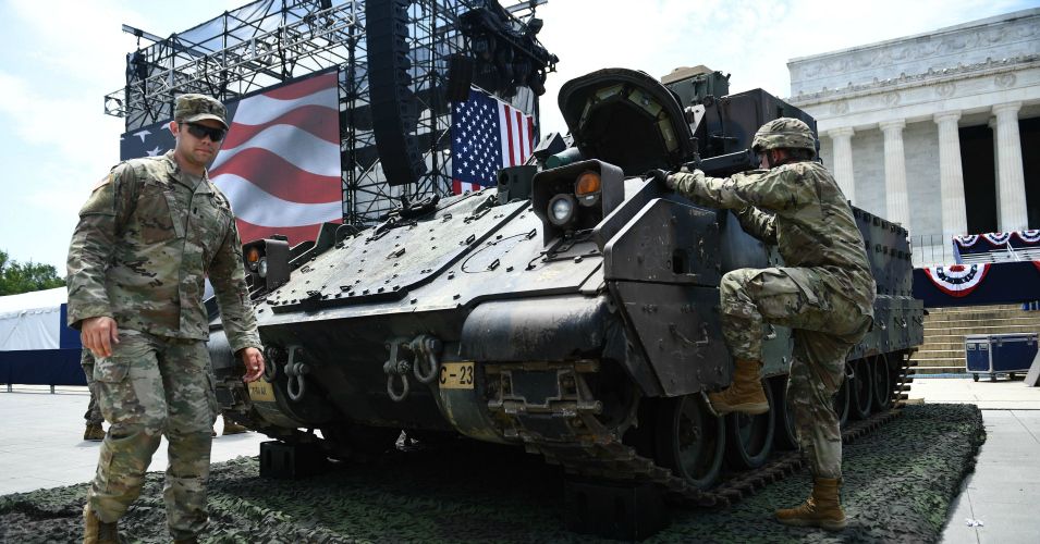 Members of the US military are seen next to a Bradley Fighting Vehicle as preparations are made for the "Salute to America" Fourth of July event with US President Donald Trump at the Lincoln Memorial on the National Mall in Washington, DC, July 3, 2019, which will feature flyovers by the Blue Angels, an airplane used as Air Force One, as well as military demonstrations and a speech by Trump. (Photo: Brendan Smialowski/AFP/Getty Images)