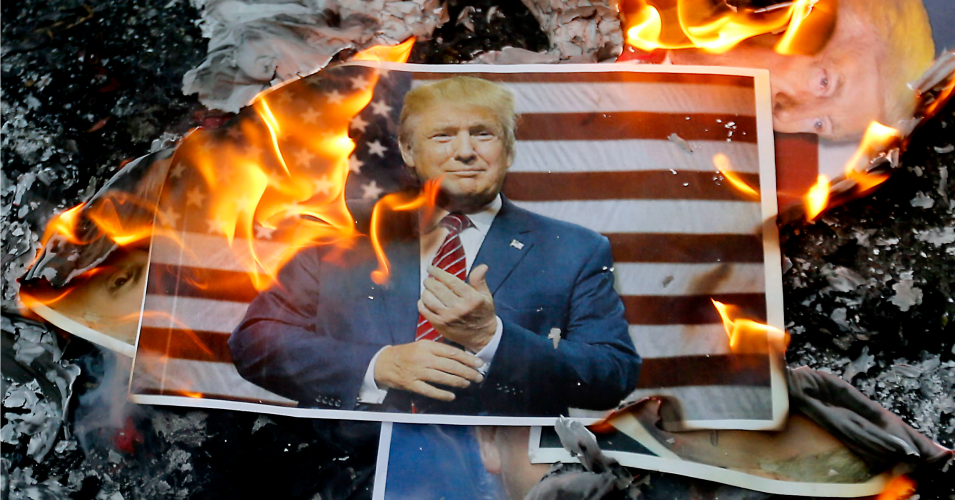 A portrait of US President Donald Trump burns during a demonstration in the capital Tehran on December 11, 2017 to denounce his declaration of Jerusalem as Israel's capital. (Photo: ATTA KENARE/AFP/Getty Images)