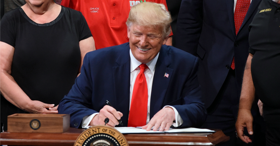 U.S. President Donald Trump signs an executive order to protect and improve Medicare at the Sharon L. Morse Performing Arts Center. (Photo: Paul Hennessy/SOPA Images/LightRocket via Getty Images)