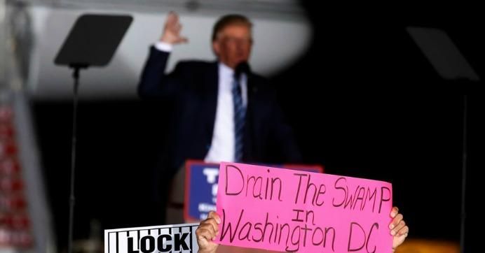 A man holds up a "Drain the Swamp in Washington DC" sign at a then- Republican presidential nominee Donald Trump rally in Kinston, North Carolina on October 26 2016.(Photo: Carlo Allegri/ Reuters)