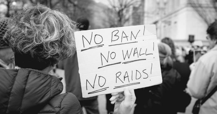 Person holds sign reading: No ban! No wall! No raids!