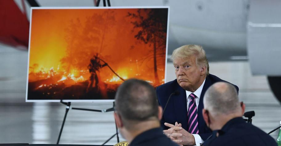 US President Donald Trump(C) listens to California Governor Gavin Newsom(D-CA) at Sacramento McClellan Airport in McClellan Park, California on September 14, 2020 during a briefing on wildfires. (Photo: Brendan Smialowski / AFP via Getty Images)