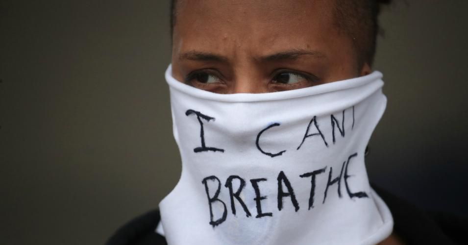 A person wears a mask that reads "I CAN'T BREATHE" as demonstrators continue to protest the death of George Floyd following a night of rioting on May 29, 2020 in Minneapolis, Minnesota. Earlier today, former Minneapolis police officer Derek Chauvin was taken into custody for Floyd's death. Chauvin has been accused of kneeling on Floyd's neck as Floyd pleaded with him about not being able to breathe. Floyd was pronounced dead a short while later. Chauvin and 3 other officers, who were involved in the arrest,
