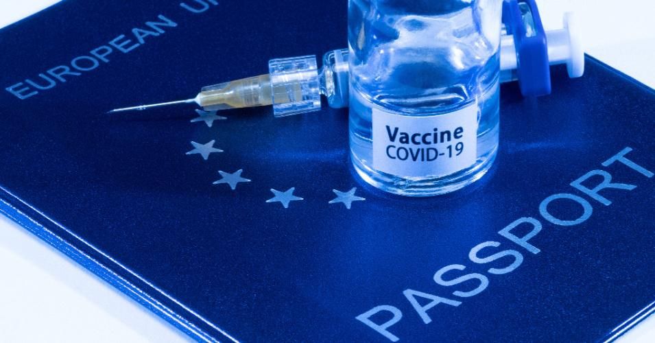 A picture taken on March 3, 2021 in Paris shows a vaccine vial reading "Covid-19 vaccine" and a syringe on an European passport. (Photo: Joel Saget/AFP via Getty Images)