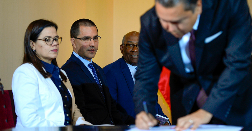 Venezuelan Foreign Minister Jorge Arreaza (2nd L) looks at opposition member Javier Bertucci during the signing of the dialogue agreement between the government and the opposition in Caracas on September 18, 2019. (Photo: Matias Delacroix/AFP/Getty Images)
