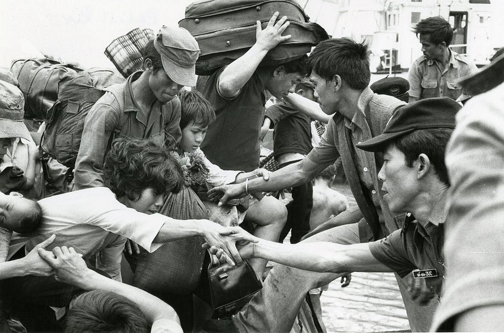 Refugees fleeing Saigon disembark from a barge, Vietnam, 1975. (Photo: Jack Cahill/Toronto Star via Getty Images)