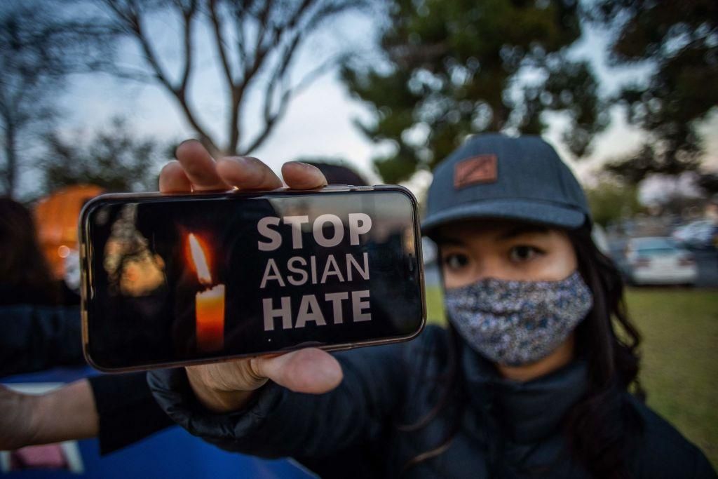 Julie Tran holds her phone during a candlelight vigil in Garden Grove, California, on March 17, 2021 to unite against the recent spate of violence targeting Asians and to express grief and outrage after yesterday's shooting that left eight people dead in Atlanta, Georgia, including at least six Asian women. (Photo: APU GOMES/AFP via Getty Images)