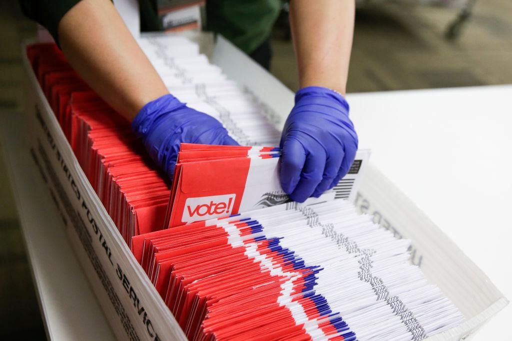 Activists are winning no-excuse mail voting and COVID-19-excuse mail voting in many states. (Photo by JASON REDMOND/AFP via Getty Images)