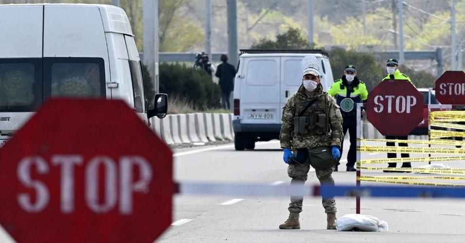 A Georgian soldiers wearing protective masks stop a car at a checkpoint in Tbilisi on April 1, 2020 amid concerns over the spread of the COVID-19 coronavirus. The coronavirus pandemic has claimed more than 30,000 lives in Europe alone, a global tally showed April 1, 2020, in what the head of the United Nations has described as humanity's worst crisis since World War II. (Photo by Vano Shlamov/ AFP via Getty Images)