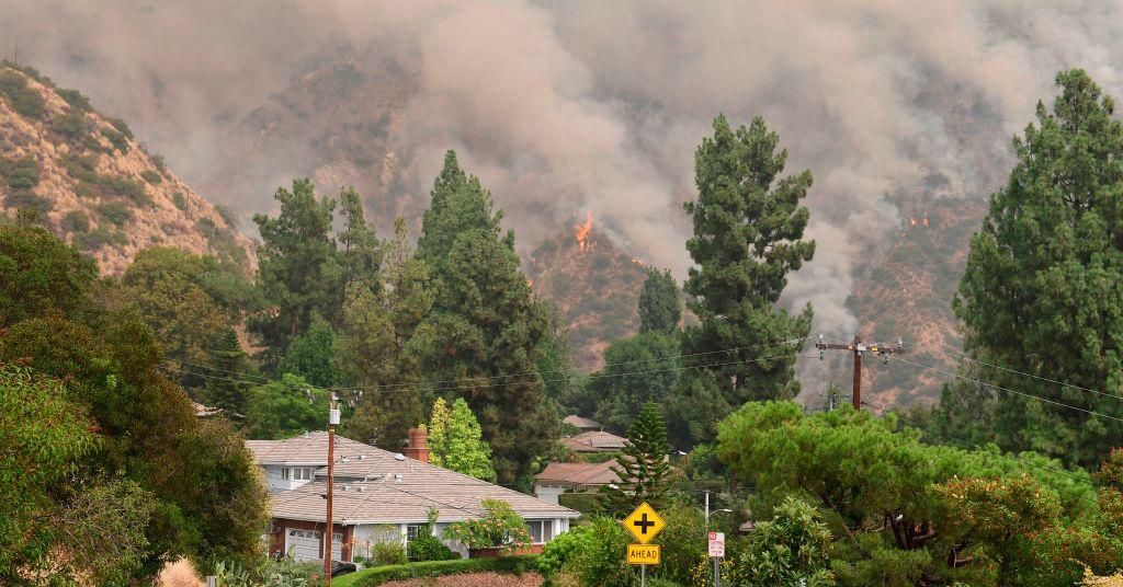 The Bobcat Fire burns on hillsides behind homes in Arcadia, California on September 13, 2020. (Photo: Frederic J. BROWN / AFP via Getty Images)