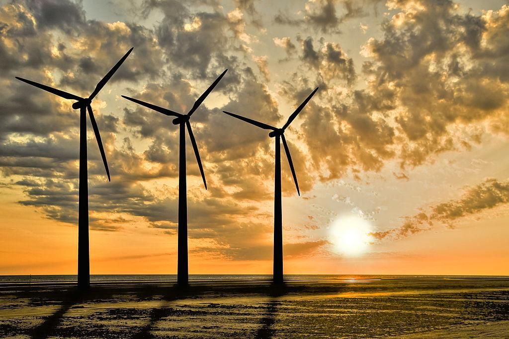 Three windturbines in sunset. (Photo by: myLoupe/Universal Images Group via Getty Images)