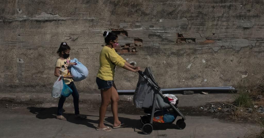 Woman and her two daughters leaving for another place after their house was destroyed during police action to vacate the houses of the favela residents in Rio De Janeiro on July 16, 2020. (Photo: Fabio Teixeira/NurPhoto via Getty Images)